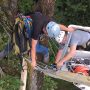 Attaching braces to help support the sticks. They are well buried under sticks and mulch.